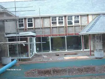 Peninsular North west Construction : Caldy Wirral. Installation of Marine Finish Allstyle Alutherm Large Polyester Powder coated Aluminium sliding Patio doors 6m wide dual sliding. Windows - White wood Heritage Vertical sliding sash with astral bar top panels ecohaus Cheshire internorm cheshire